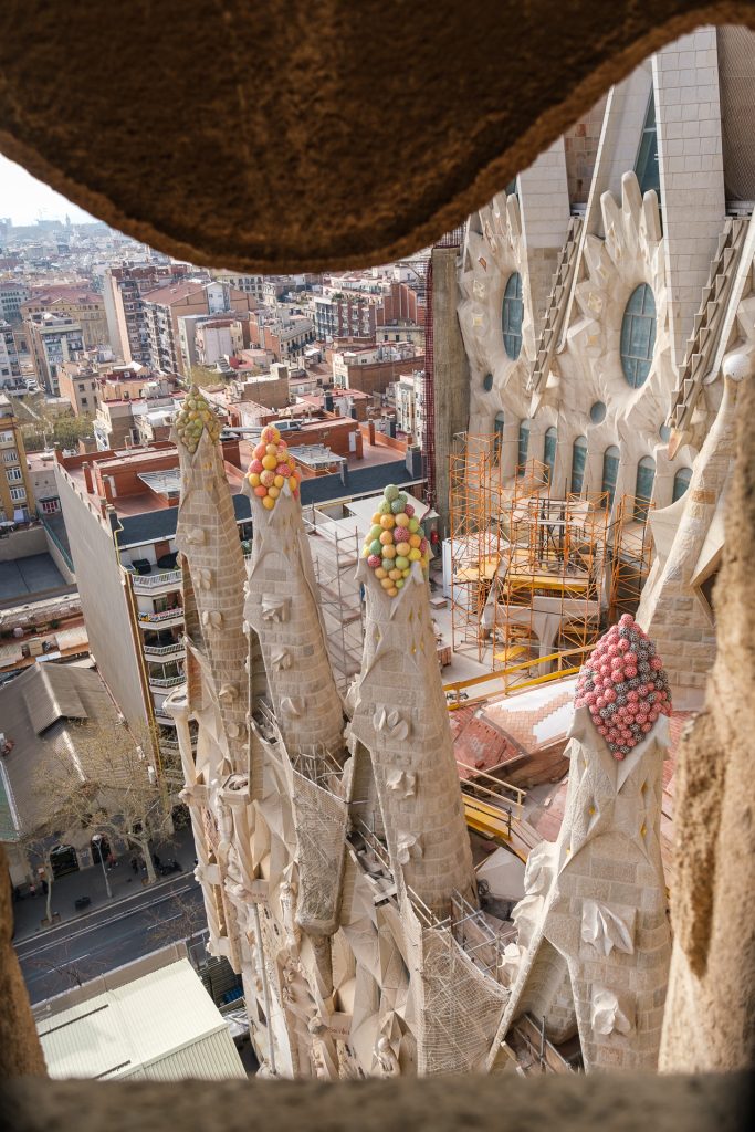 Candy-colored tops of stone window frames seen from the outside of the Nativity tower.