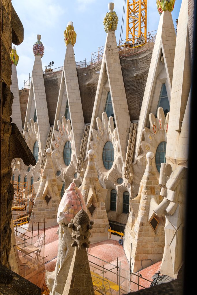 Candy-colored tops of stone window frames seen from the outside of the Nativity tower.