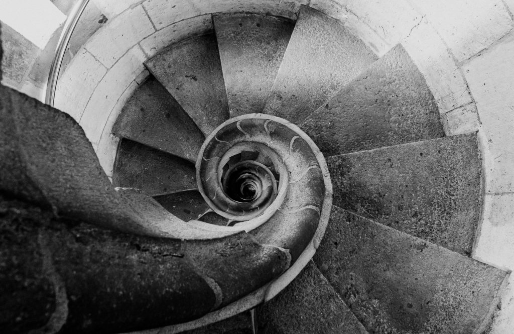 Black and white photo of the spiral stairs in the Nativity tower, looking down the center.